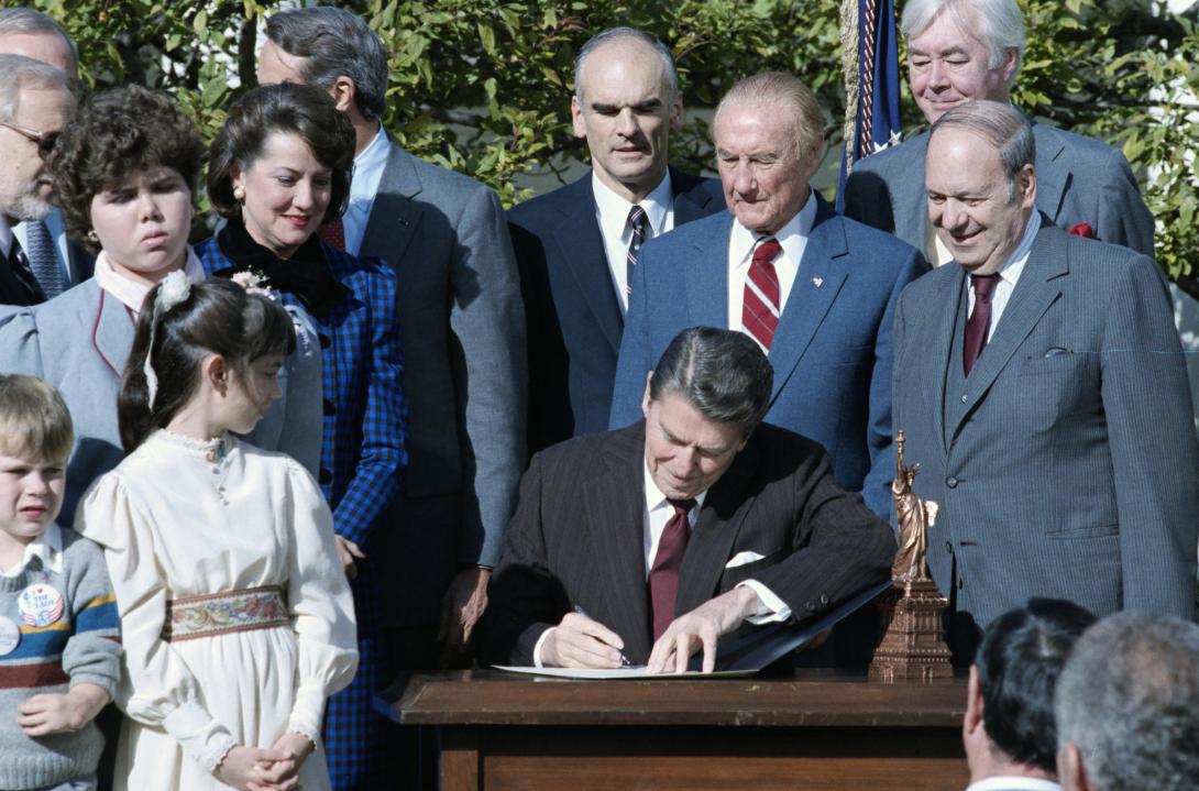 President Ronald Reagan signing H.J. Res. 407, a joint resolution designating the 12-month period pending on October 28, 1986 as the “Centennial year of Liberty in the United States,” in the Rose Garden