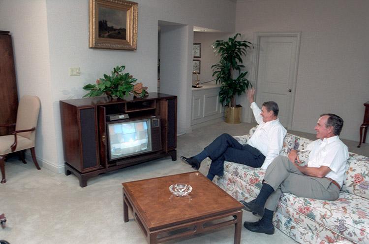 President Ronald Reagan and Vice President George Bush watching Nancy Reagan on television at the Republican National Convention from their hotel in Dallas, Texas 08/22/1984