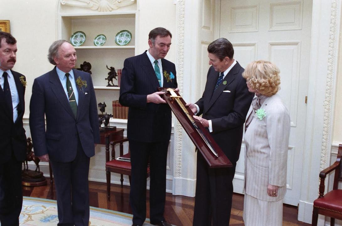 President Ronald Reagan receiving a replica of a Viking sword marking the 1,000th anniversary of Dublin in the Oval Office with the U.S. Ambassador to Ireland Margaret Heckler, 03/17/1988
