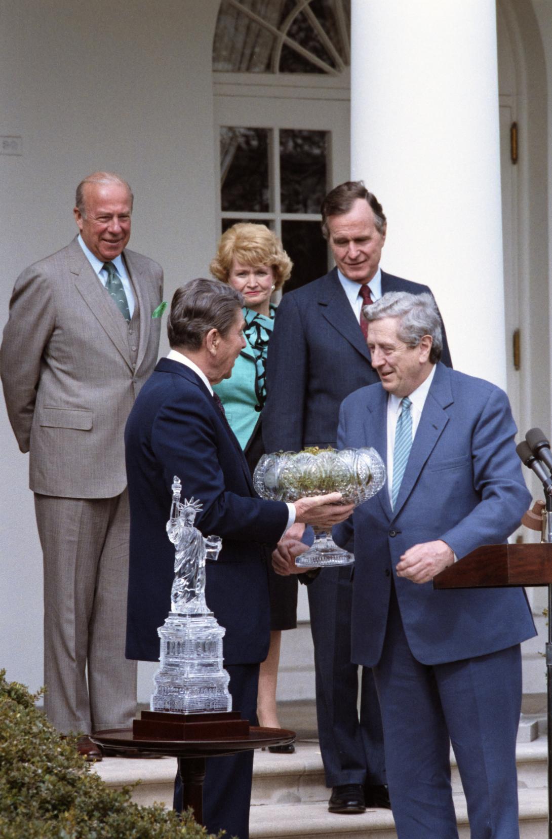 President Ronald Reagan receiving a Waterford crystal bowl filled with shamrocks from Prime Minister Garret FitzGerald of Ireland during a ceremony in celebration of St. Patrick’s Day, 03/17/1986