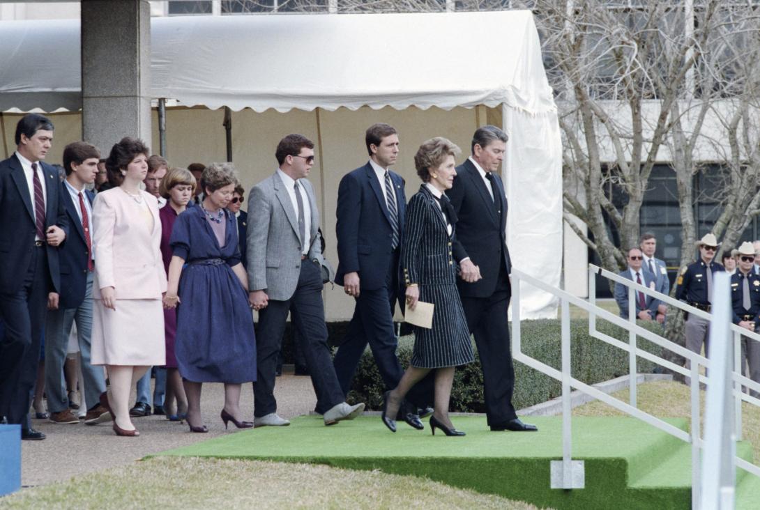 President Ronald Reagan and Nancy Reagan walking to their seats at the memorial service for the crew of the Space Shuttle Challenger in Houston, Texas. 01/31/1986. C33152-16.