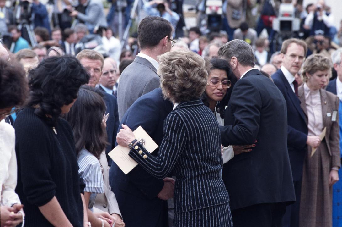 Nancy Reagan and President Ronald Reagan hugging families of the crew of the Space Shuttle Challenger. 01/31/1986. C33147-28A.
