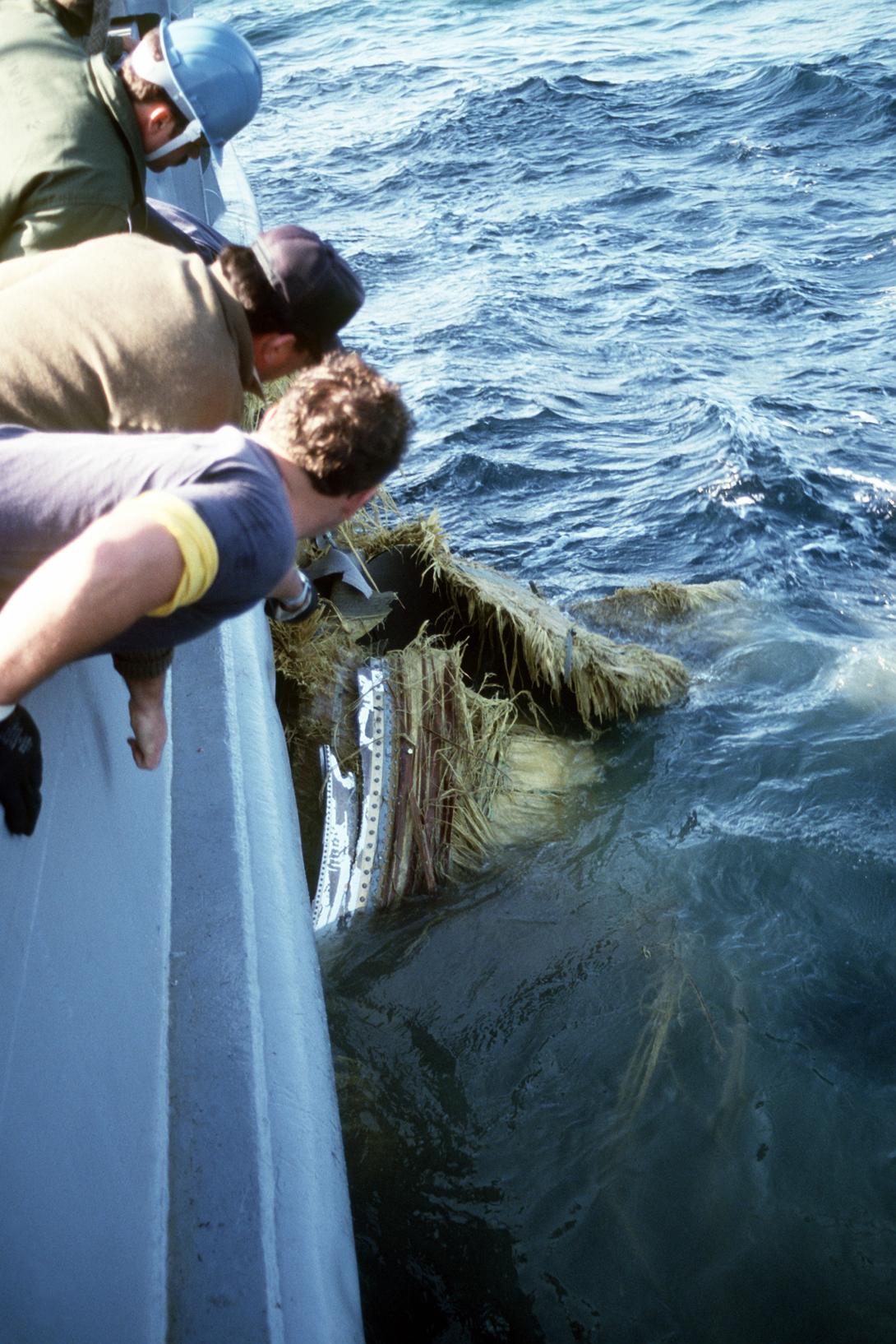 Crew members aboard the salvage ship USS PRESERVER (ARS-8) haul a piece of debris aboard the ship during recovery operations for the Space Shuttle Challenger Record Group 330: Records of the Office of the Secretary of Defense 1921-2008 Series: Combined Military Service Digital Photographic Files 1982-2007 Produced: January 1, 1986. Local ID: 330-CFD-DN-ST-86-06836. NAID: 6410168.