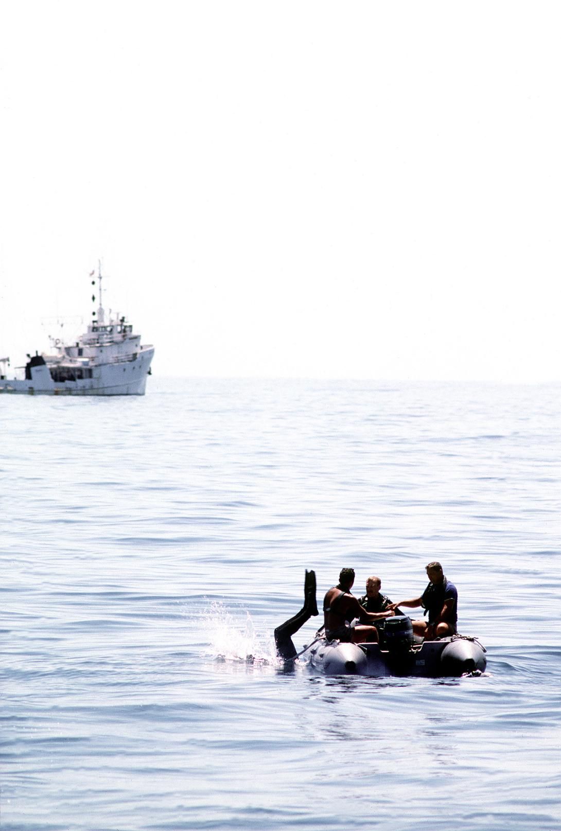 A diver goes overboard from an inflatable dinghy during salvage operations for the space shuttle orbiter Challenger. In the background is the salvage ship USS PRESERVER (ARS-8) Record Group 330: Records of the Office of the Secretary of Defense 1921-2008 Series: Combined Military Service Digital Photographic Files 1982-2007 Produced: January 1, 1986. Local ID: 330-CFD-DN-ST-87-02414. NAID: 6421637.