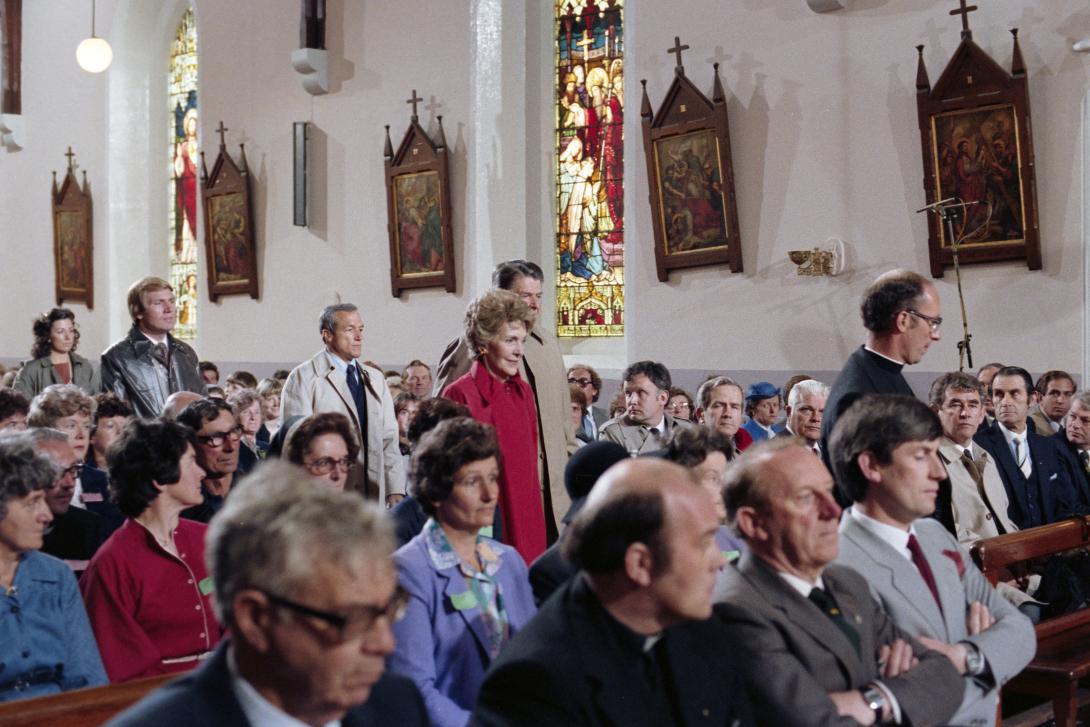 President Ronald Reagan and Nancy Reagan proceeding to their seats for Parish Prayer Service at Church of the Assumption in Ballyporeen, Ireland, 06/03/1984