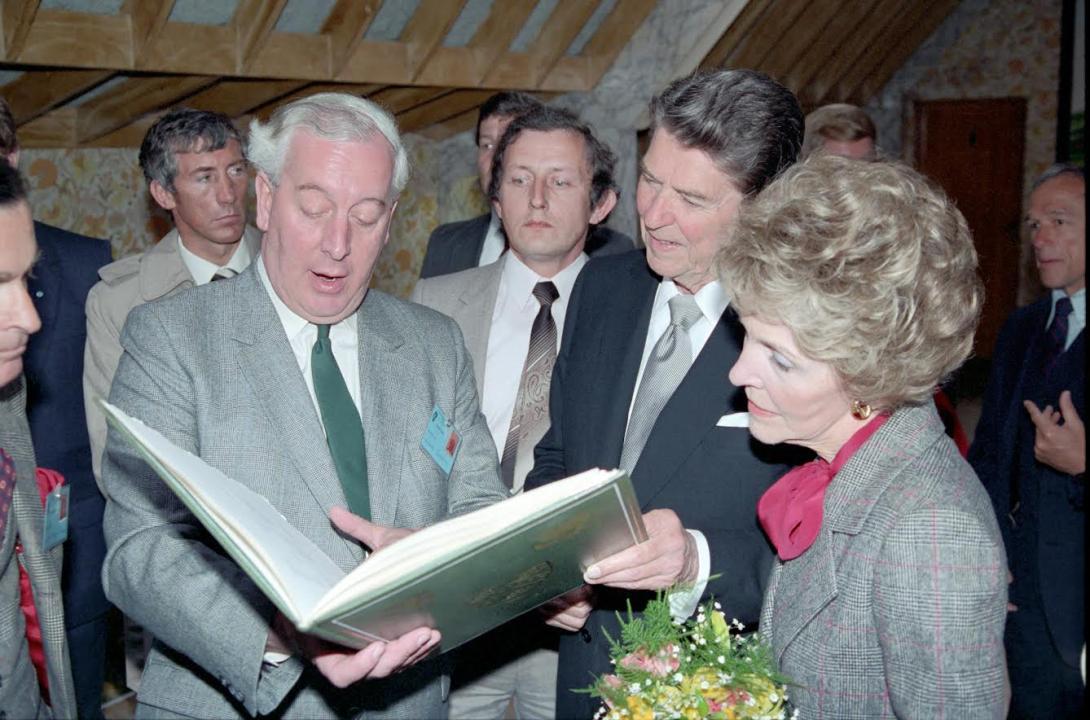 President Ronald Reagan with Nancy Reagan being presented with a copy of his family tree by Hugh Peskett at O’Farrell’s Pub in Ballyporeen, Ireland, 06/03/1984
