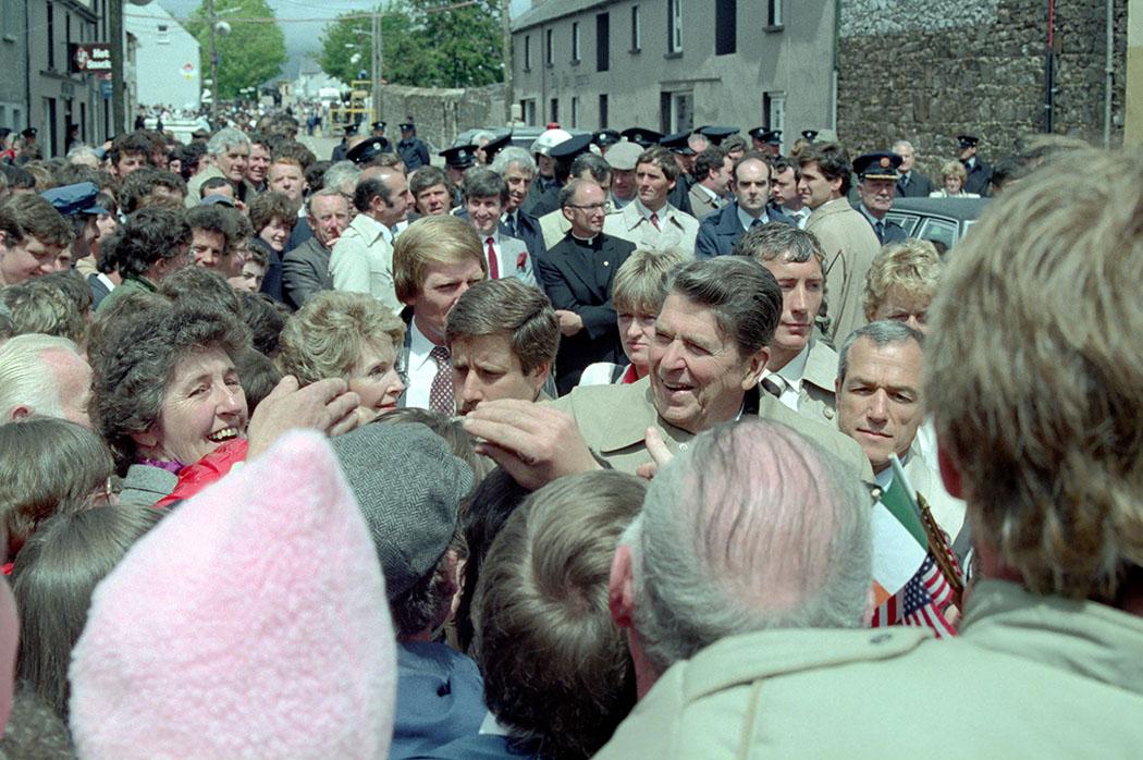 President Ronald Reagan and Nancy Reagan walking through the town of Ballyporeen, Ireland, 06/03/1984