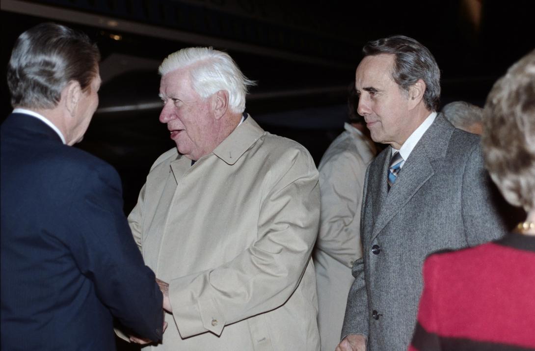 President Ronald Reagan greeting Speaker of the House Thomas Phillip “Tip” O’Neill with Senator Robert “Bob” Dole upon arriving at Andrews Air Force Base via Air Force One from Brussels, Belgium, 11/21/1985