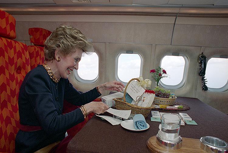 Nancy Reagan looking at a gift basket during a trip to New York aboard the First Lady Airplane dated 10/25/1988 NAID: 276565005