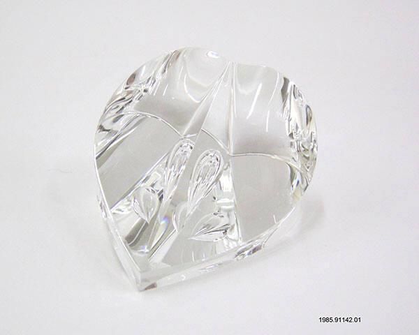 A clear glass sculpture of a heart. The sculpture is known as the “Caring Heart Award,” given to First Lady Nancy Reagan. Gifted by the : Congressional Families for Drug-free Youth.