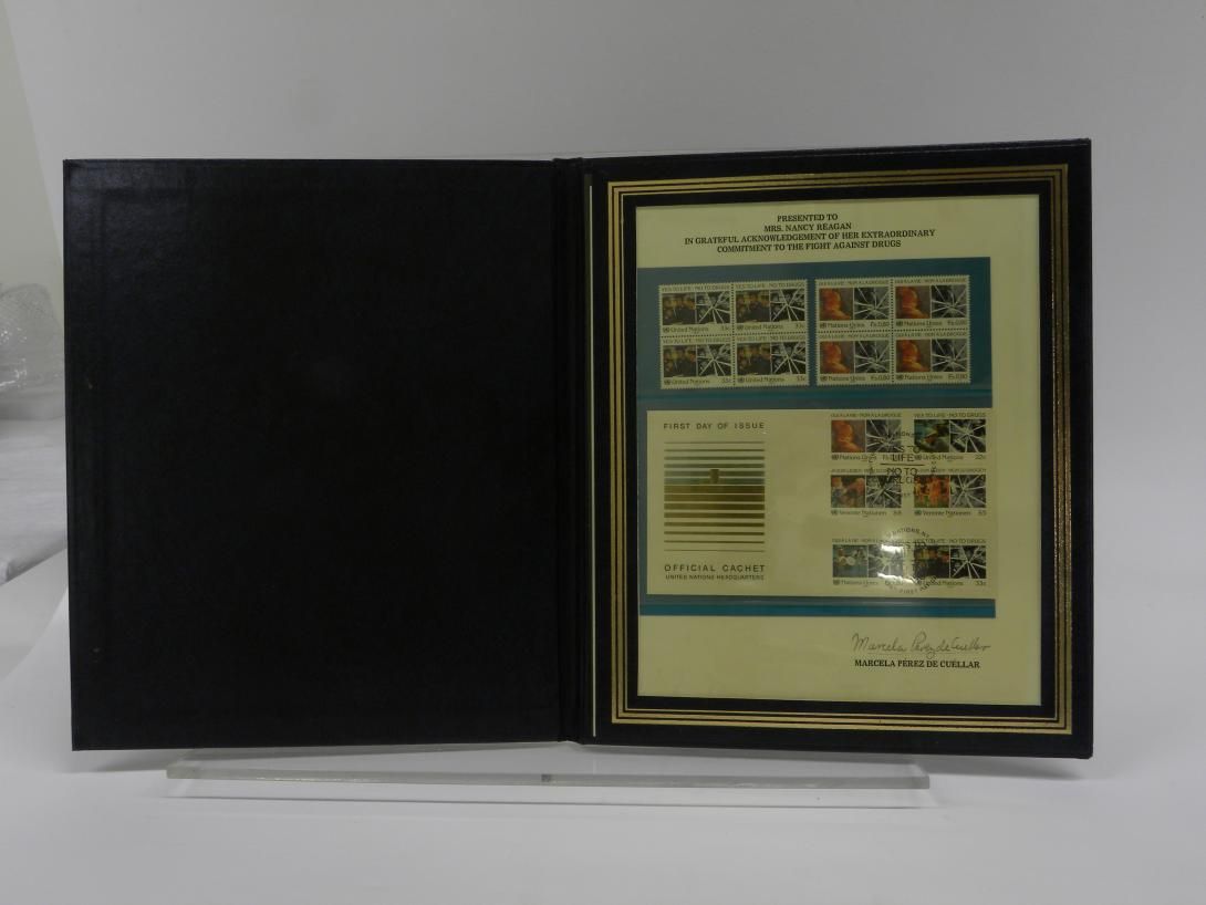 Stamp Album, Official Cachet United Nations Headquarters - United Nations Stamp, blue leatherette album of the first day cover cachet and stamps for “Yes To Life – No To Drugs” United Nations Stamp. Inscribed inside of the album states “PRESENTED TO MRS. NANCY REAGAN IN GRATEFUL ACKNOWLEDGEMENT OF HER EXTRAORDINARY COMMITMENT TO THE FIGHT AGAINST DRUGS.”