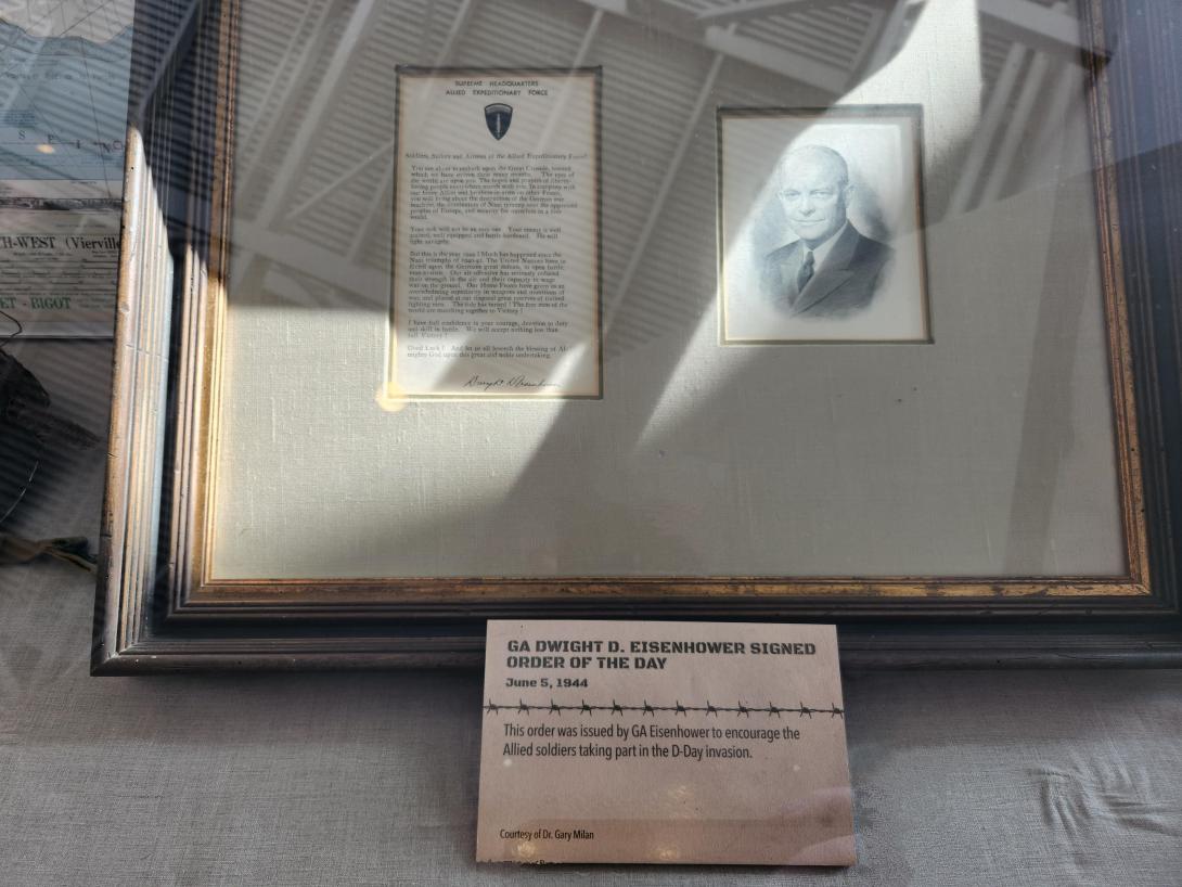 Framed image of Dwight D. Eisenhower and a copy of the signed order of the day
