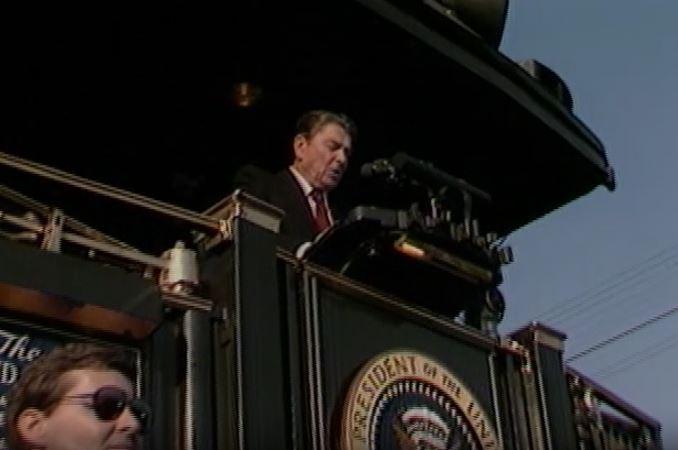 10/12/1984 Master Tape #035 (NAID: 137878358) Trip to Ohio. President Reagan aboard train, cuts shots of crowd during President Ronald Reagan’s speech in Deshler. Cuts of Perrysburg speech